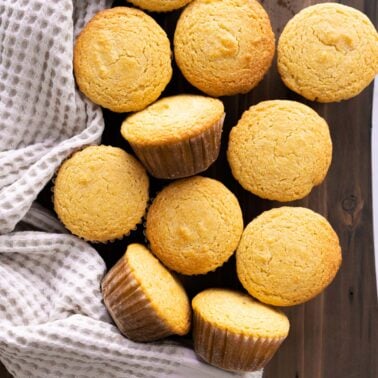 Healthy cornbread muffins on a wooden board and with linen towel.