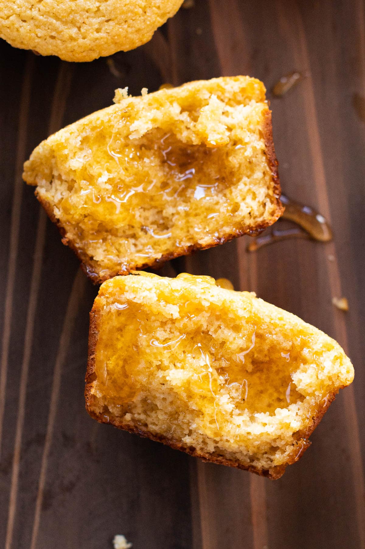 Cornbread muffin split in half and drizzled with honey.