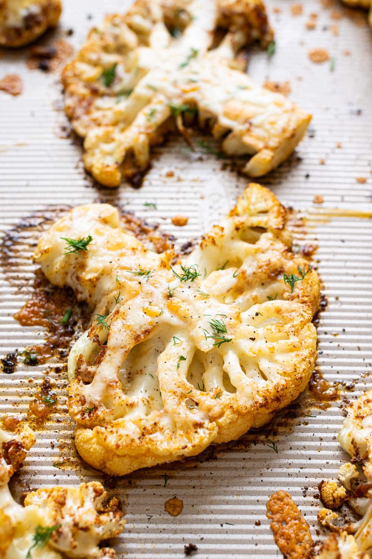 Side view of baked cauliflower steak with cheese.