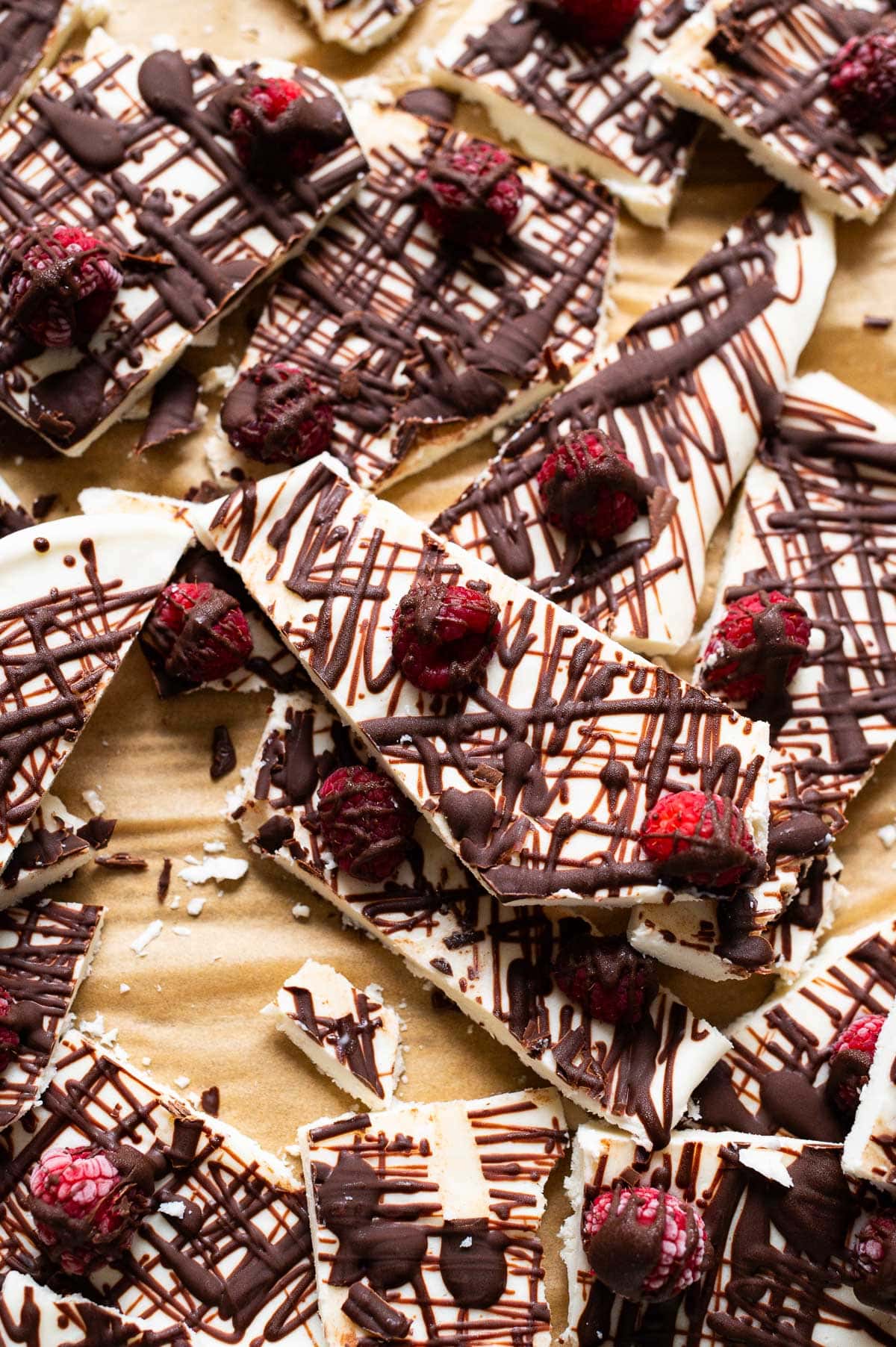 Close up view of cottage cheese bark with raspberries and chocolate drizzle.