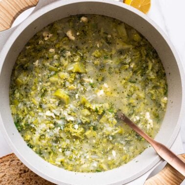 Broccoli feta soup in a pot with ladle.