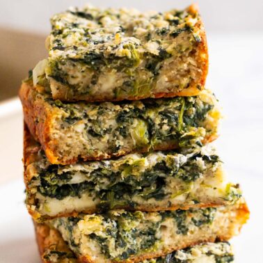 A stack of five spinach and feta brownies.