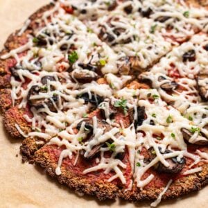 Vegan cauliflower pizza crust with mushrooms and cheese.