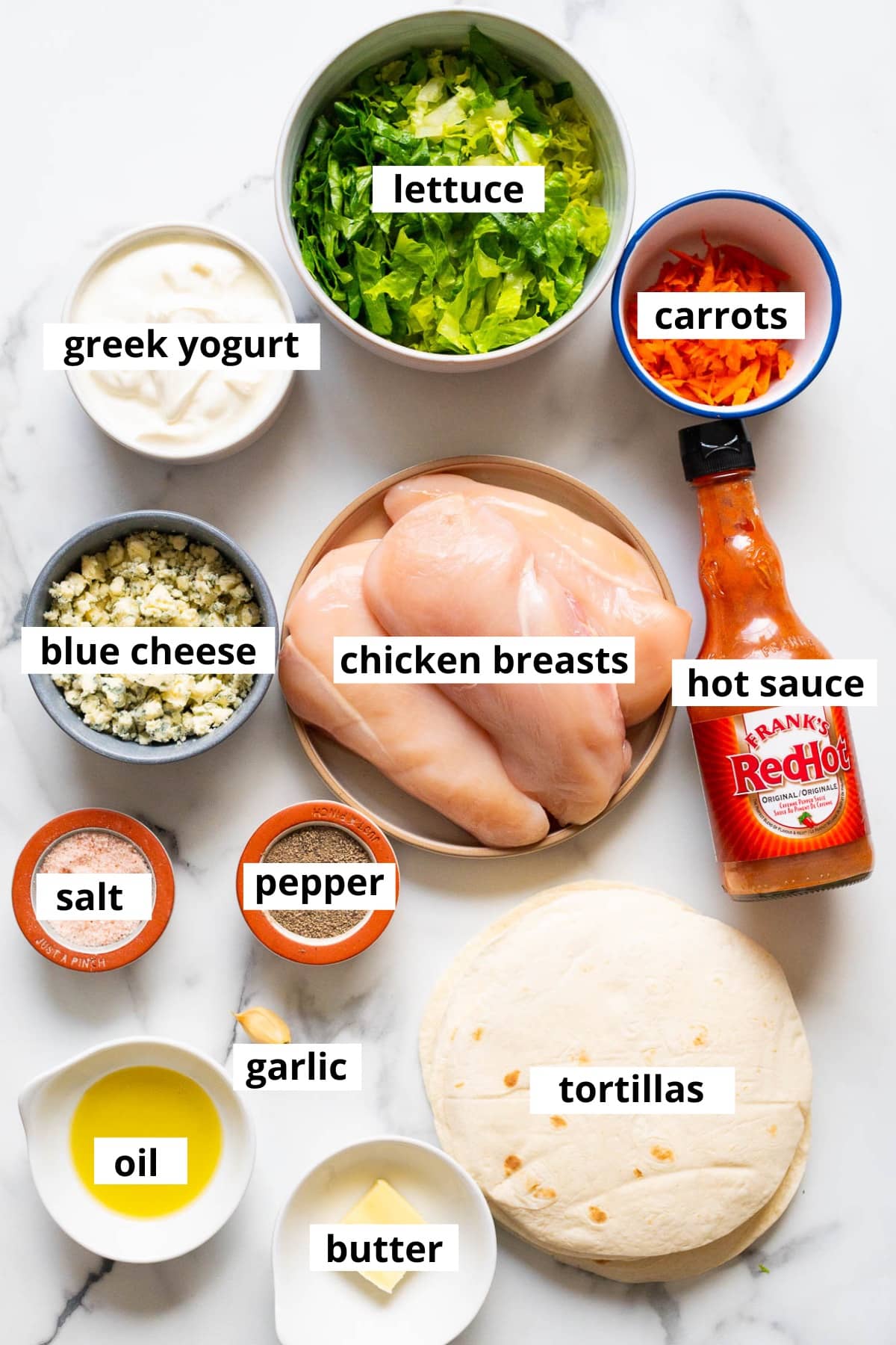 Chicken breasts, blue cheese, hot sauce, carrots, lettuce, yogurt, salt, pepper, tortillas, garlic, oil, butter.