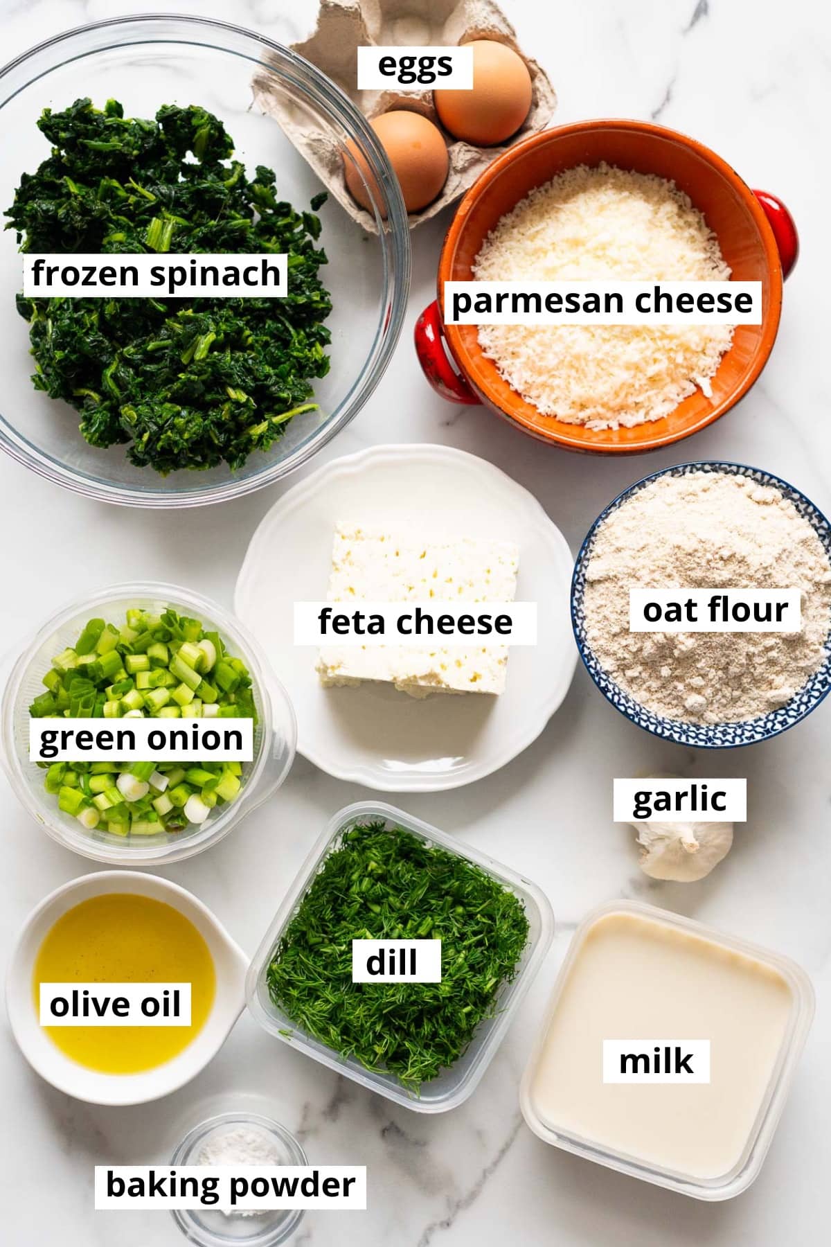 Frozen spinach, feta cheese, parmesan cheese, eggs, oat flour, green onion, garlic, dill, milk, olive oil, baking powder.
