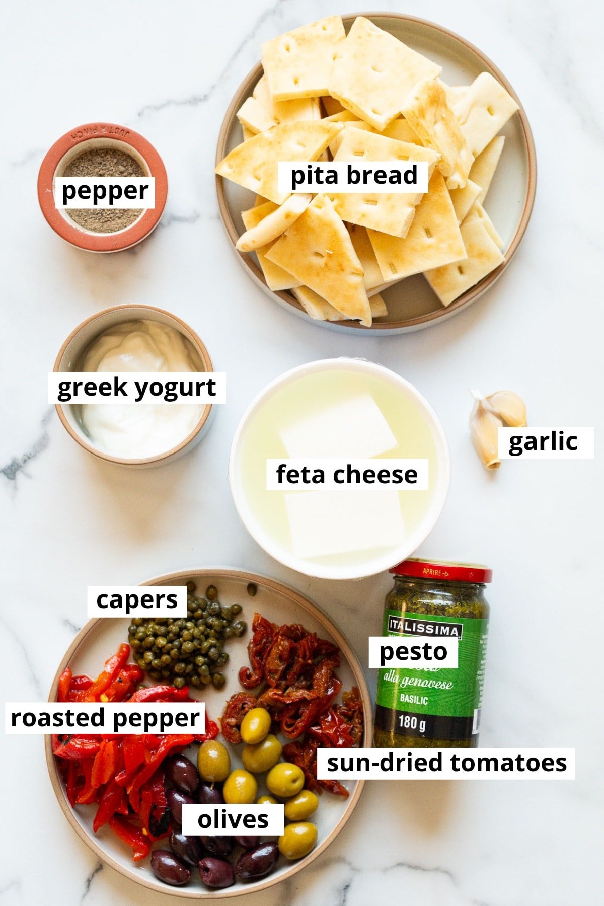 Feta cheese, greek yogurt, garlic, pepper, pita bread, pesto, sun dried tomatoes, capers, roasted pepper, olives.