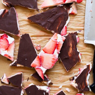 Strawberry bark cut into slices on parchment paper.