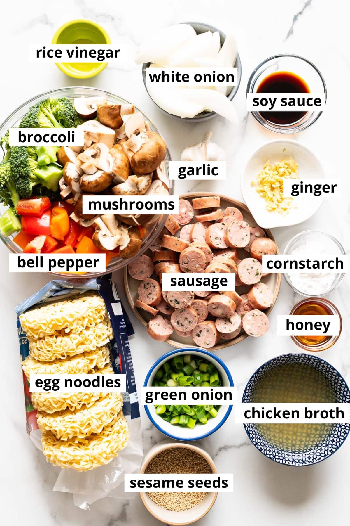 Sausage, broccoli, bell pepper, mushrooms, garlic, ginger, onion, soy sauce, rice vinegar, cornstarch, honey, egg noodles, green onion, chicken broth, sesame seeds.