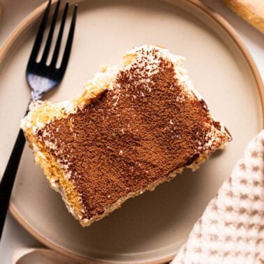 Cottage cheese tiramisu served on a plate with a fork.
