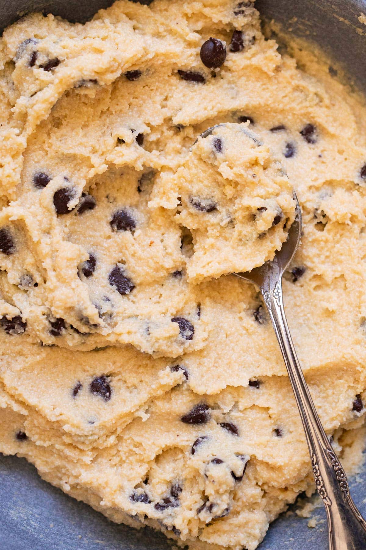 Close up of cottage cheese cookie dough stirred with a spoon.