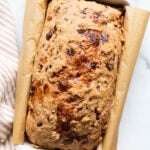 Cottage cheese bread in a loaf pan and linen towel.