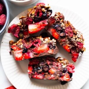 Four chocolate berry bars on a plate.