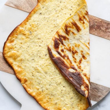 Cottage cheese flatbread folded in half on a platter.