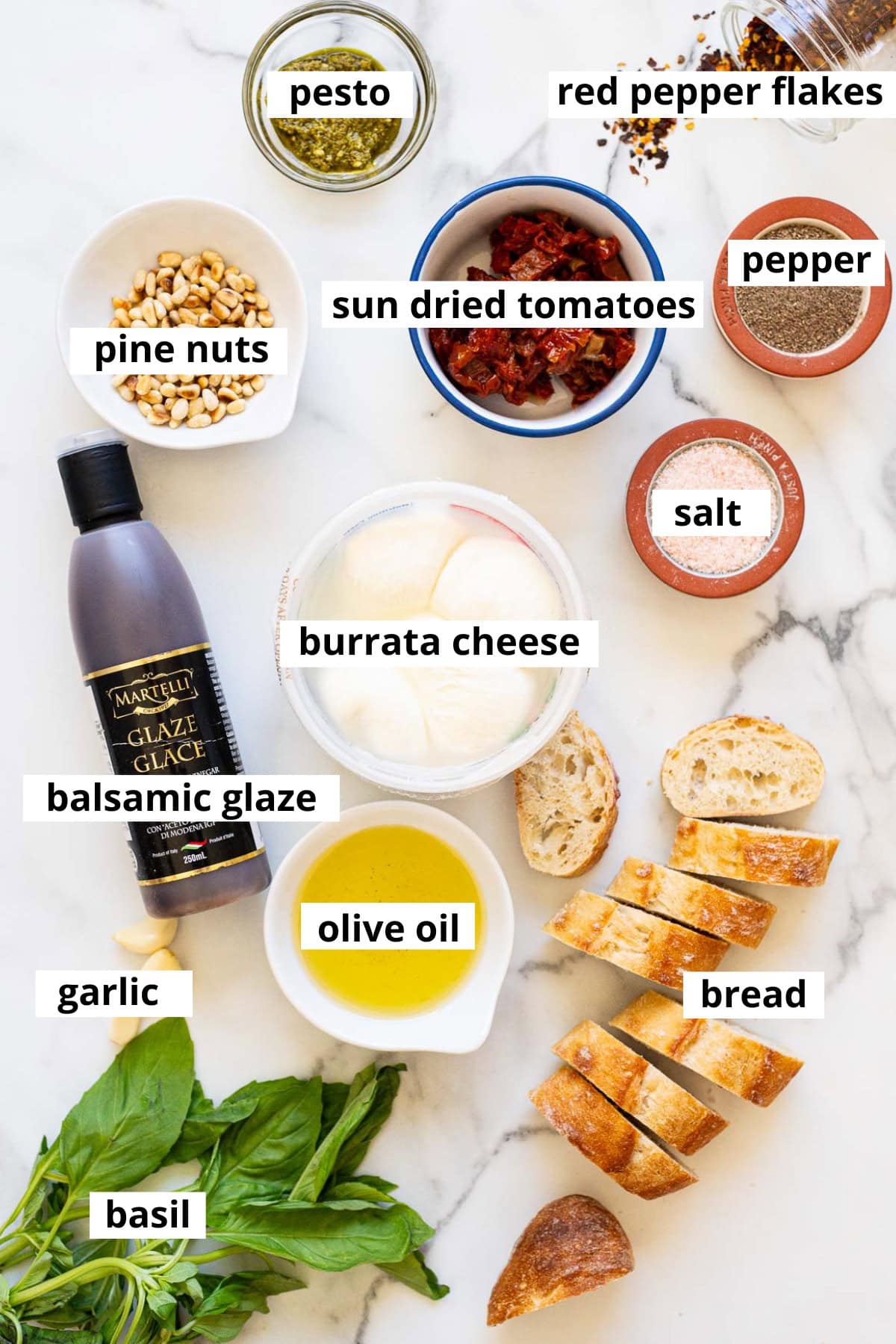 Pesto, red pepper flakes, salt, pepper, pine nuts, sun-dried tomatoes, balsamic glaze, burrata cheese, olive oil garlic, basil, bread.
