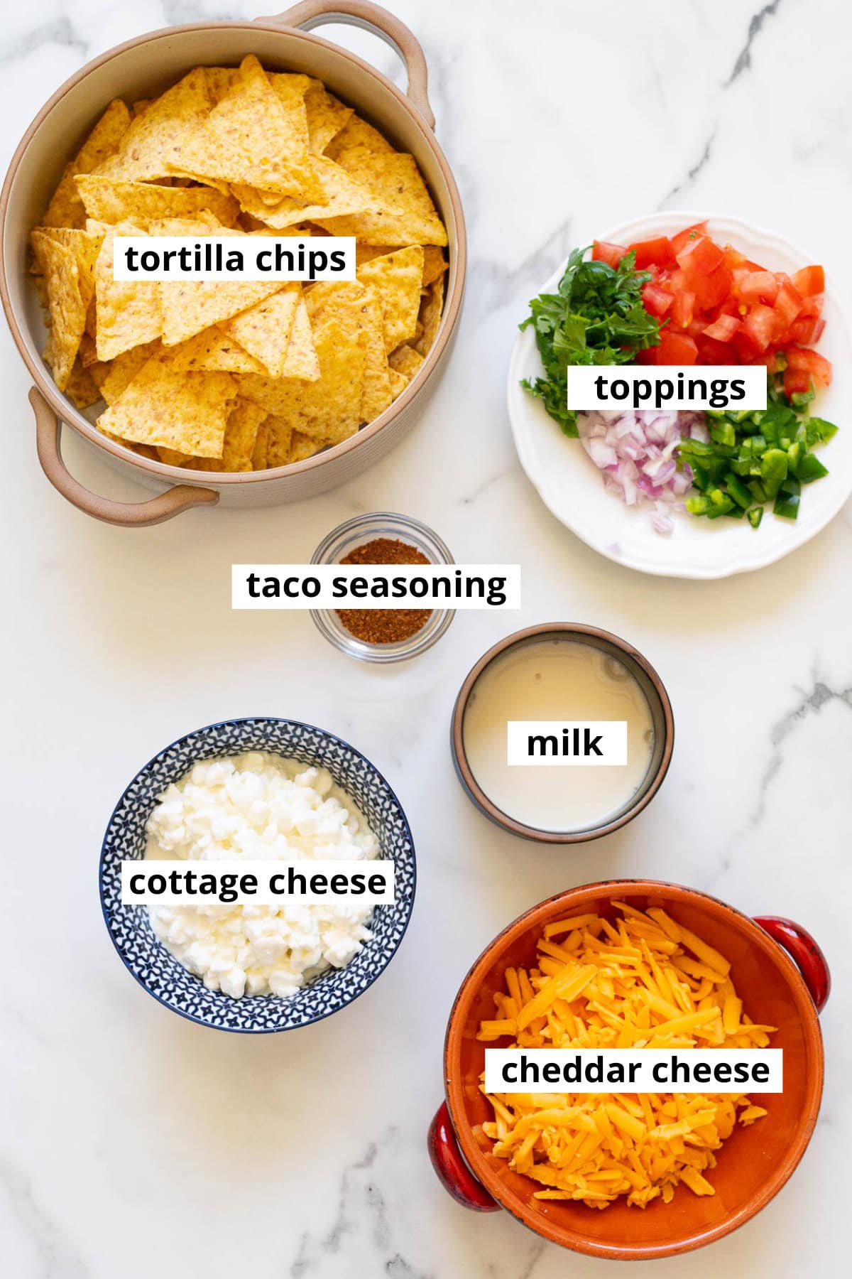 Tortilla chips, cottage cheese, taco seasoning, milk, red onion, jalapeno, cilantro, tomato.