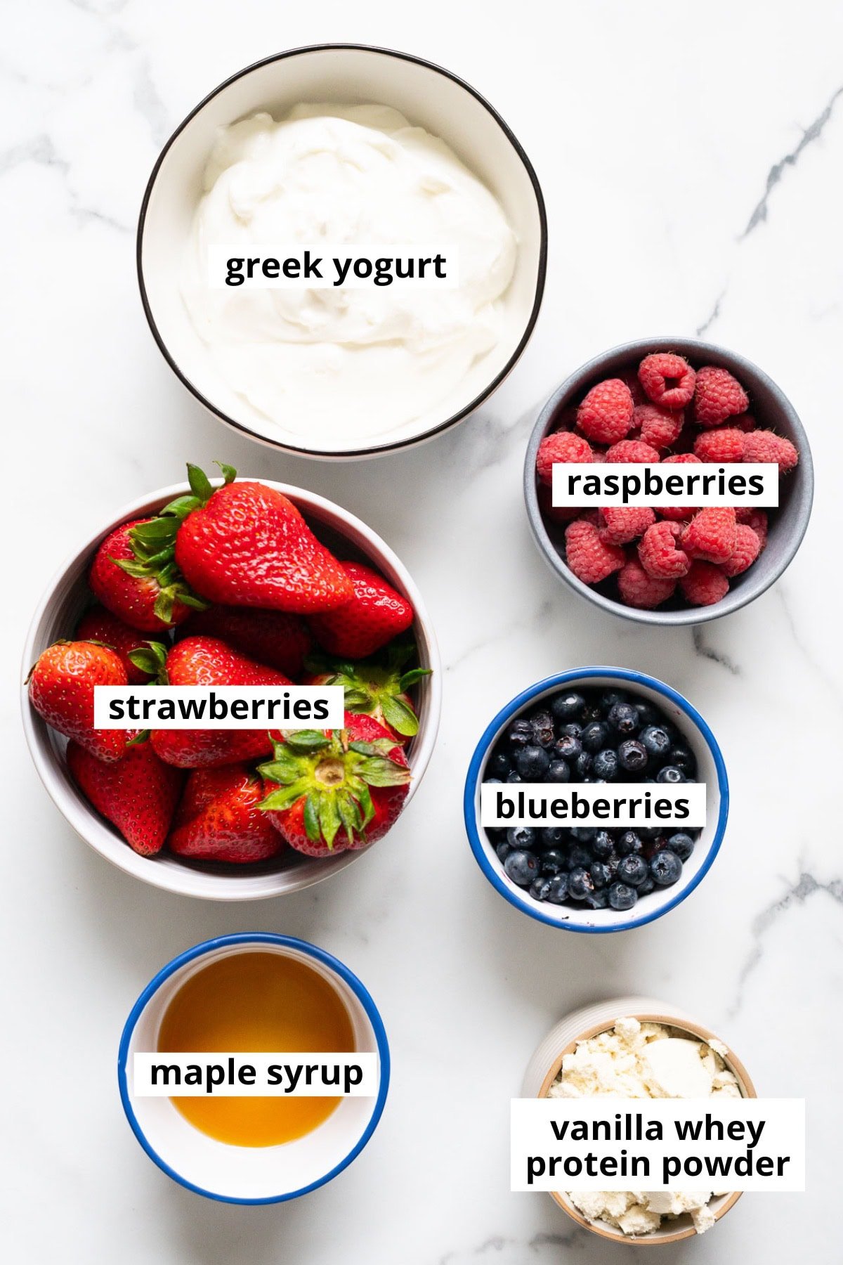 Greek yogurt, raspberries, strawberries, blueberries, maple syrup, vanilla whey protein powder.