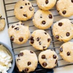 Cottage cheese cookies when a cooling rack. Cottage cheese and chocolate chips in bowls.