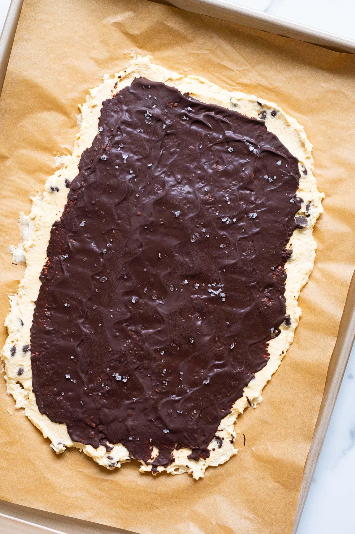 Protein cookie dough bark on a baking sheet lined with parchment paper.