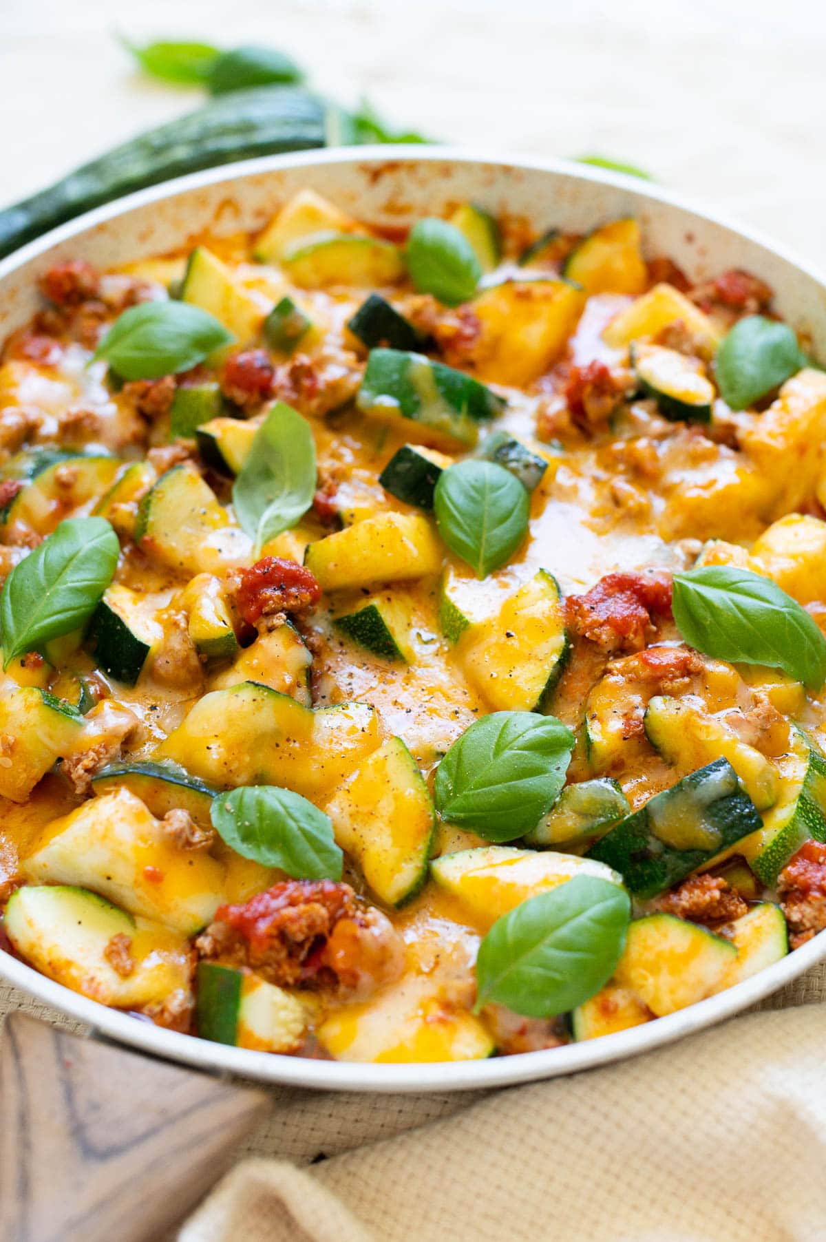 Zucchini pizza skillet garnished with basil.