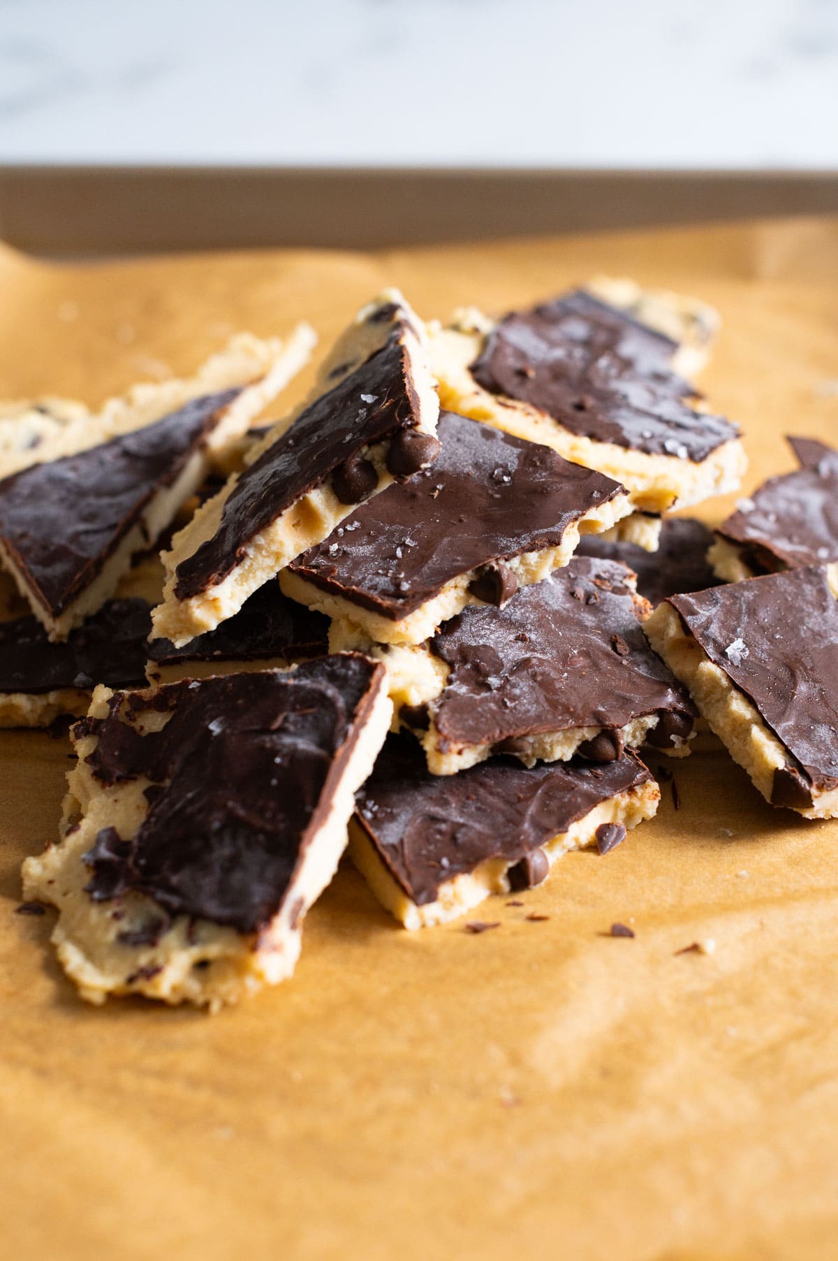 High protein cookie dough bark in a pile on a baking sheet.