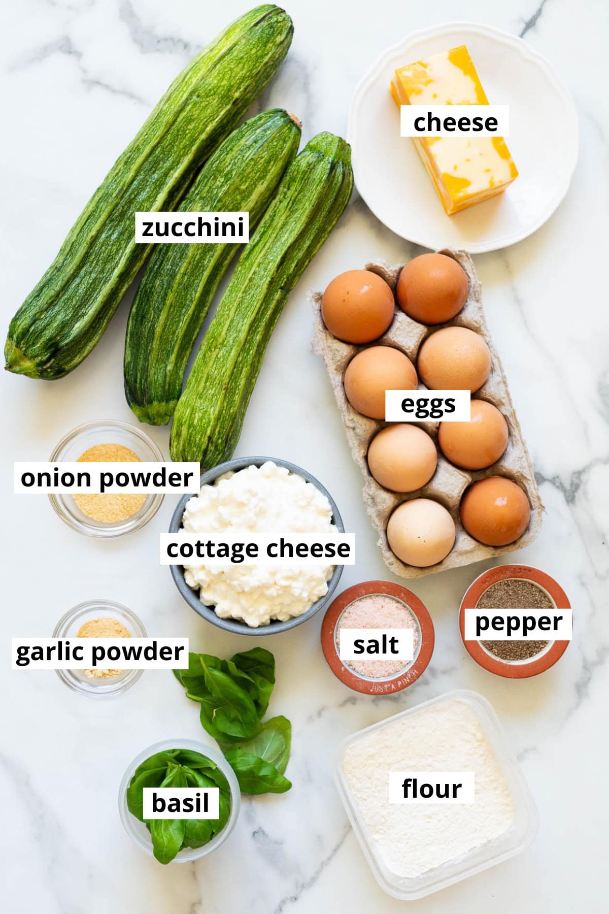 Zucchini, eggs, cottage cheese, onion powder, cheese, garlic powder, basil, flour, salt and pepper.