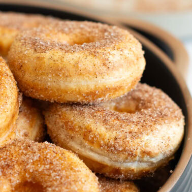 Close up side view of Greek yogurt donuts coated in cinnamon sugar.