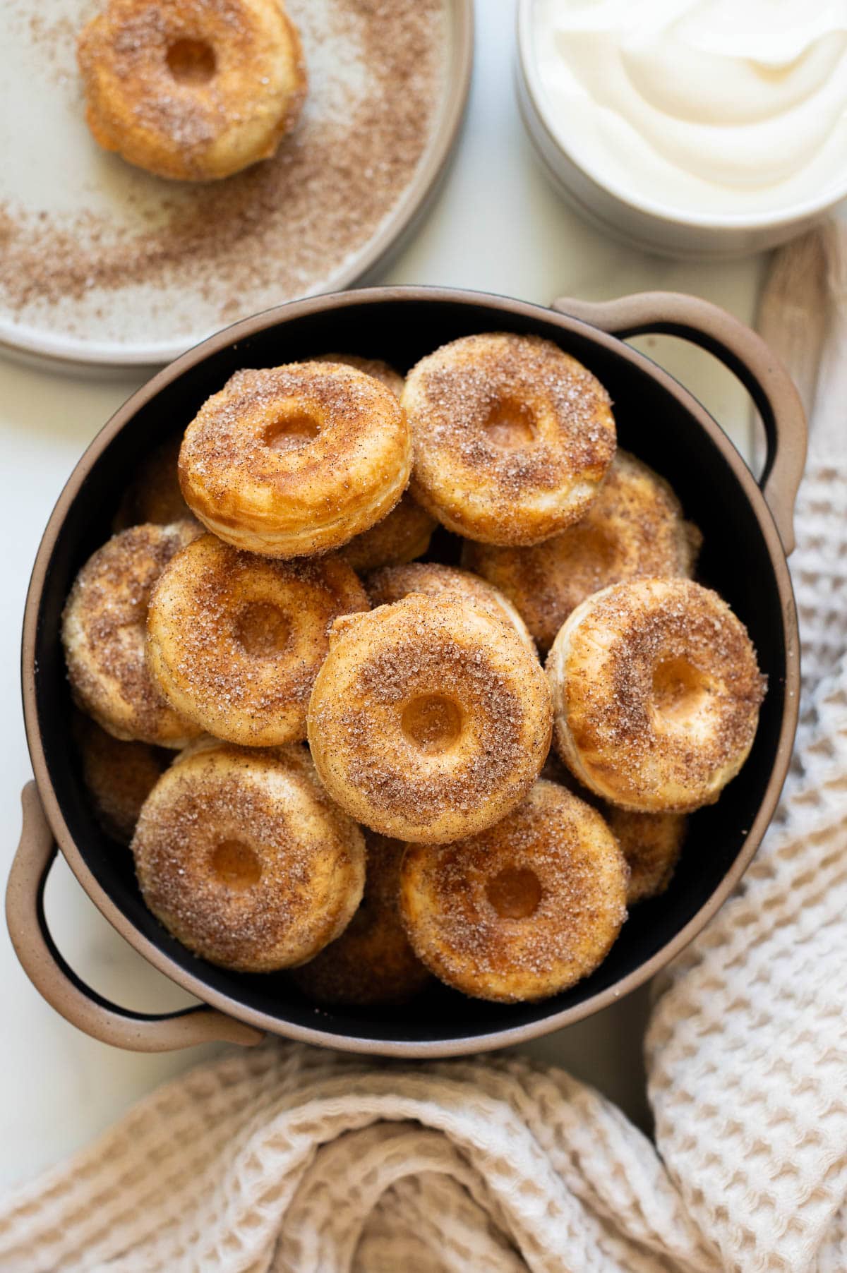 Greek yogurt Donuts in a bowl. Greek yogurt in a bowl, donut on a plate and towel on the counter.