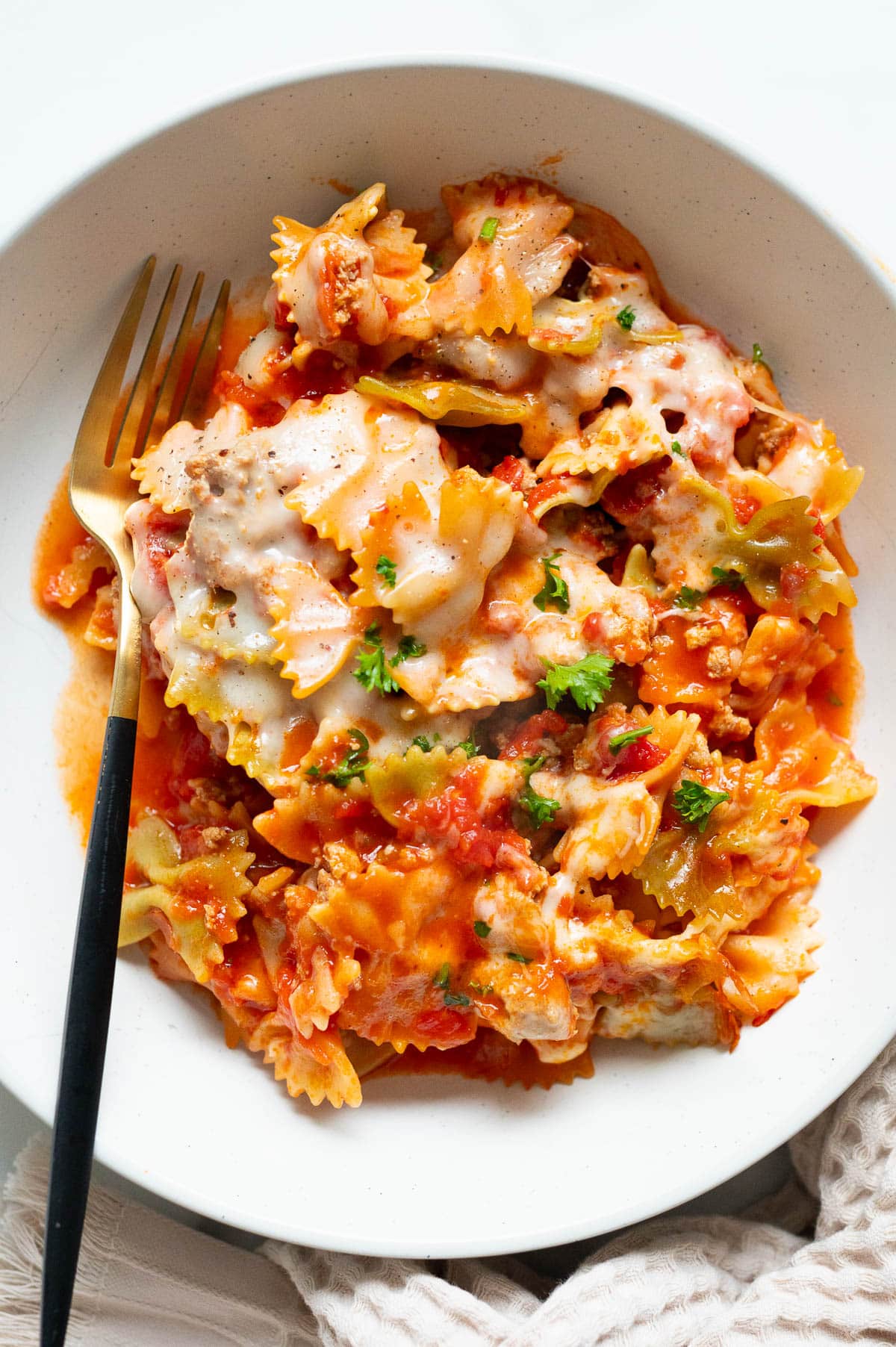 Pasta dish served in a bowl with a fork.