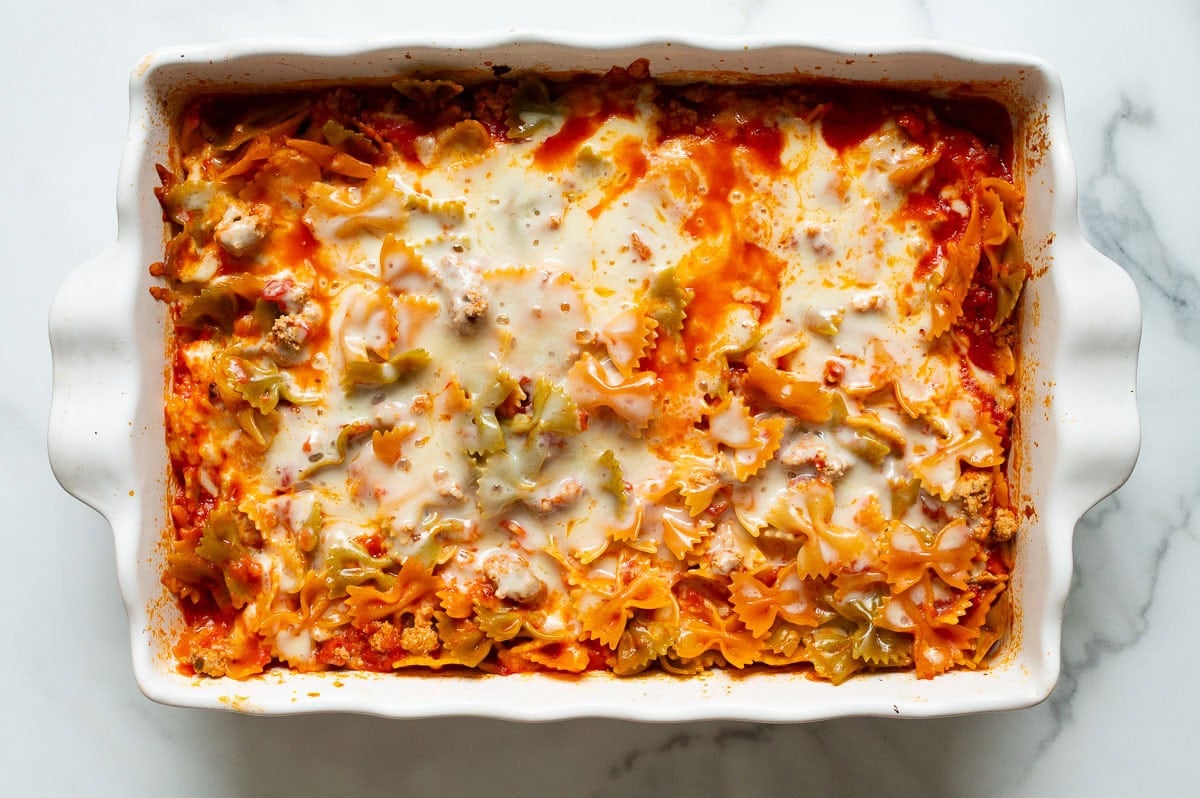 Pasta cooked with marinara and cheese in a baking dish.