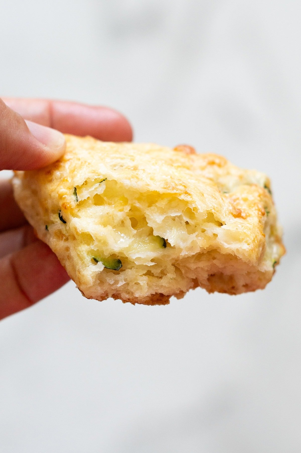 Person holding half of the scone showing texture inside.