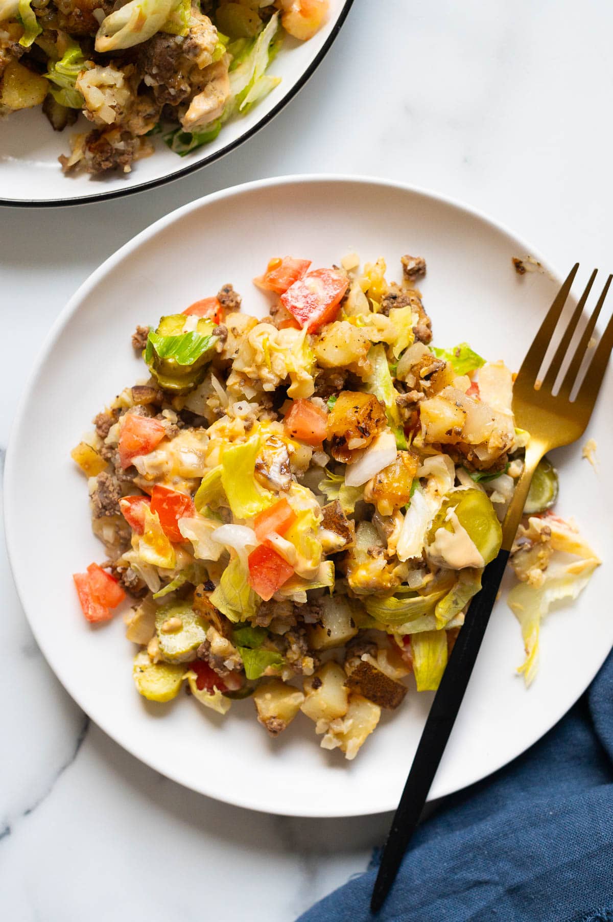 Big Mac casserole served on a plate with a fork.