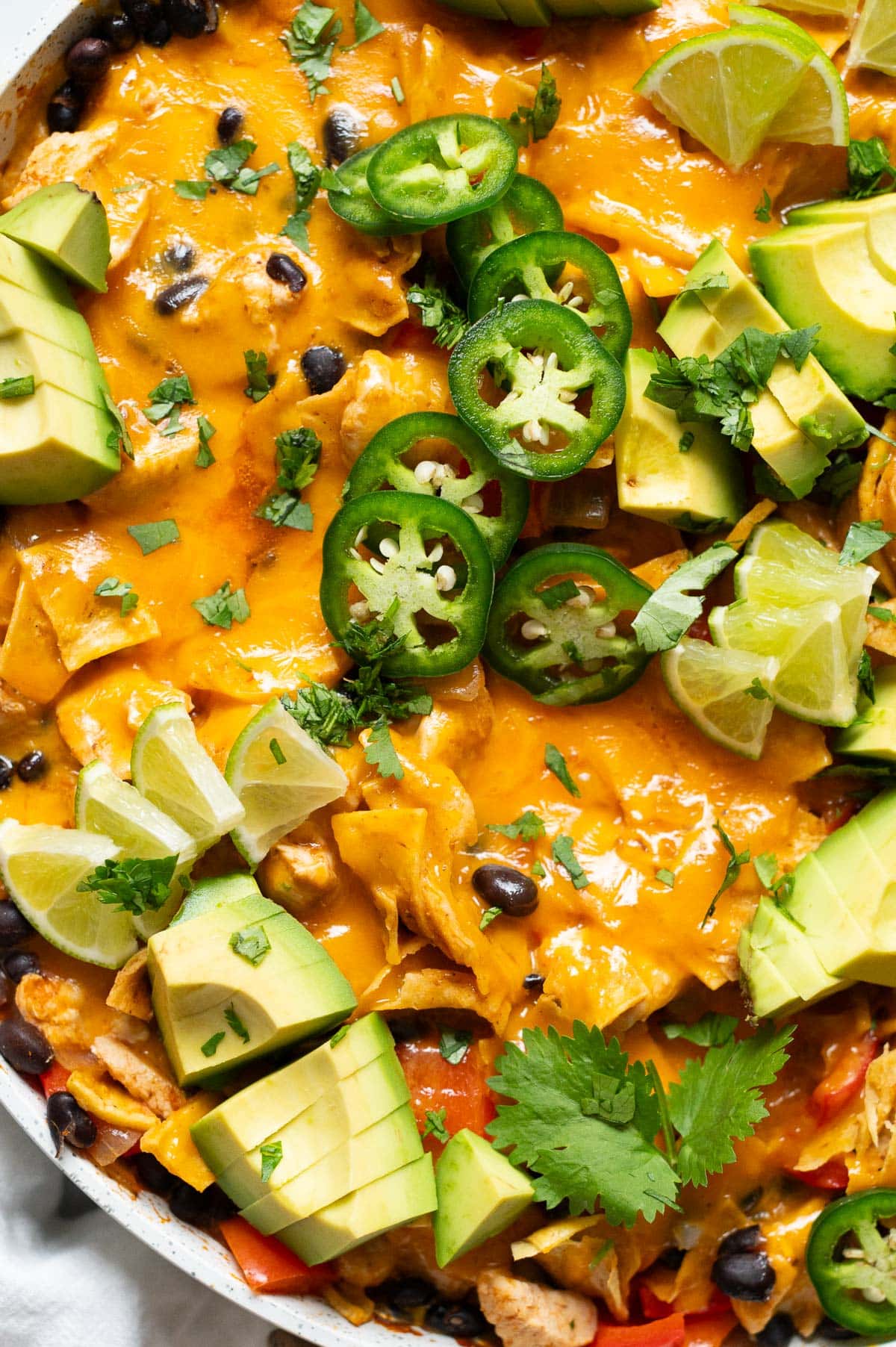 Close up of chicken enchiladas in a skillet.