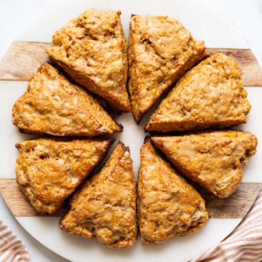 8 pumpkin cottage cheese scones served on a platter.