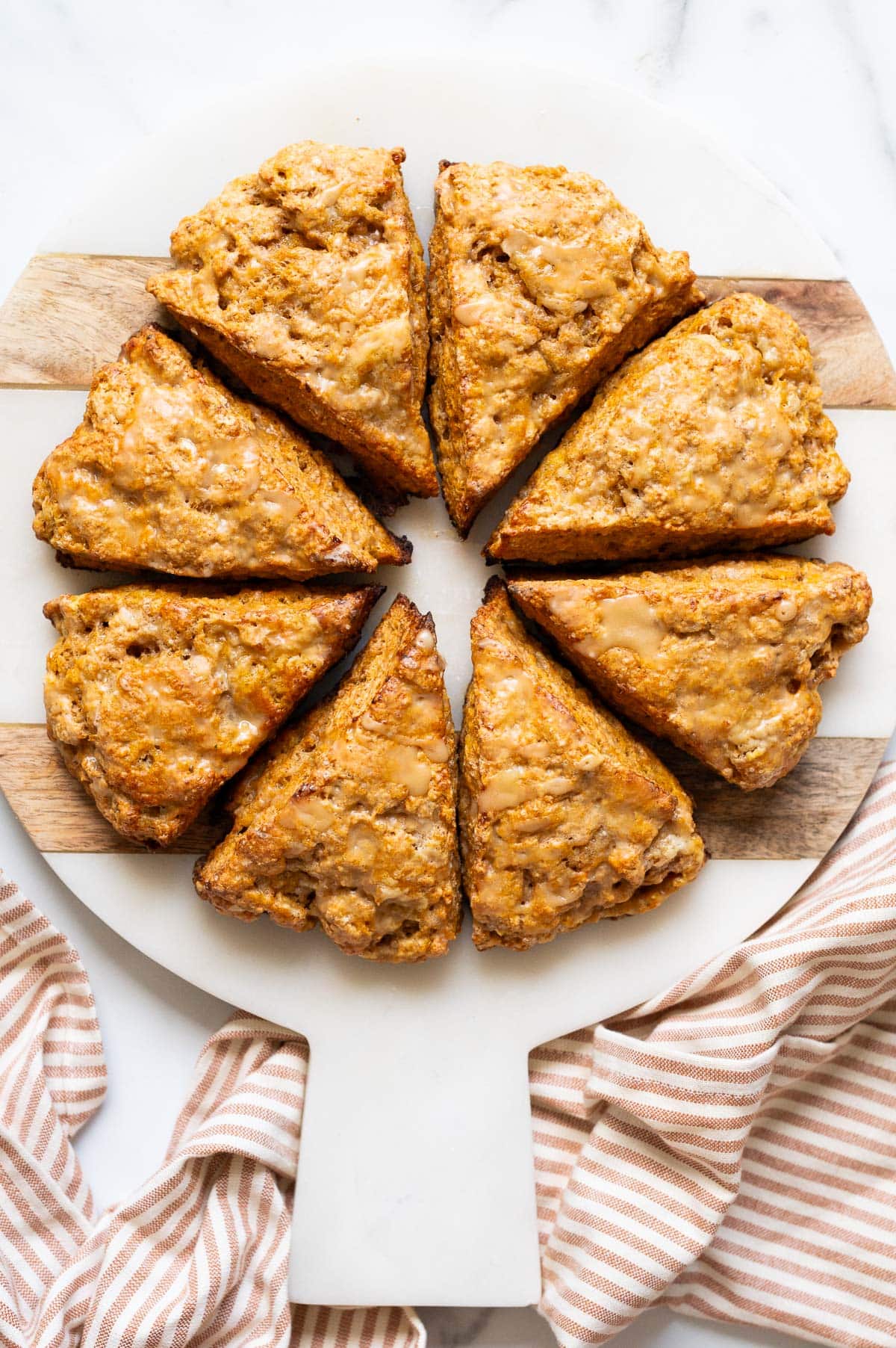 8 pumpkin cottage cheese scones served on a platter.