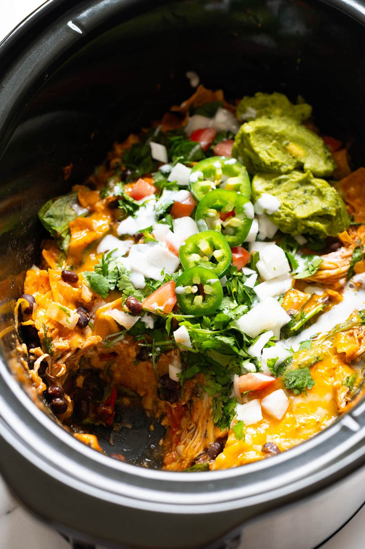 Crock pot chicken enchilada casserole showing texture inside.