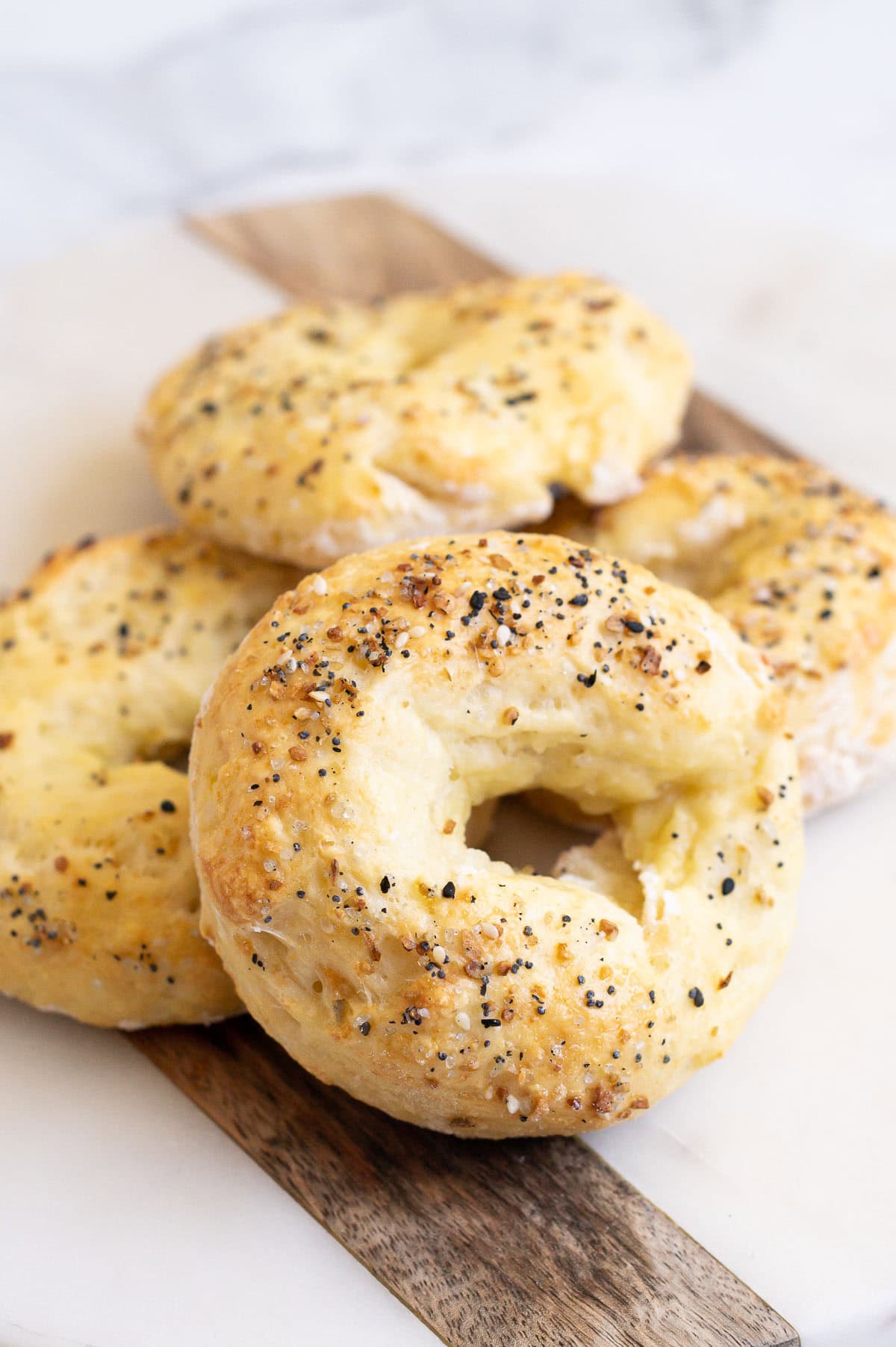 Four cottage cheese bagels topped with everything bagel seasoning.