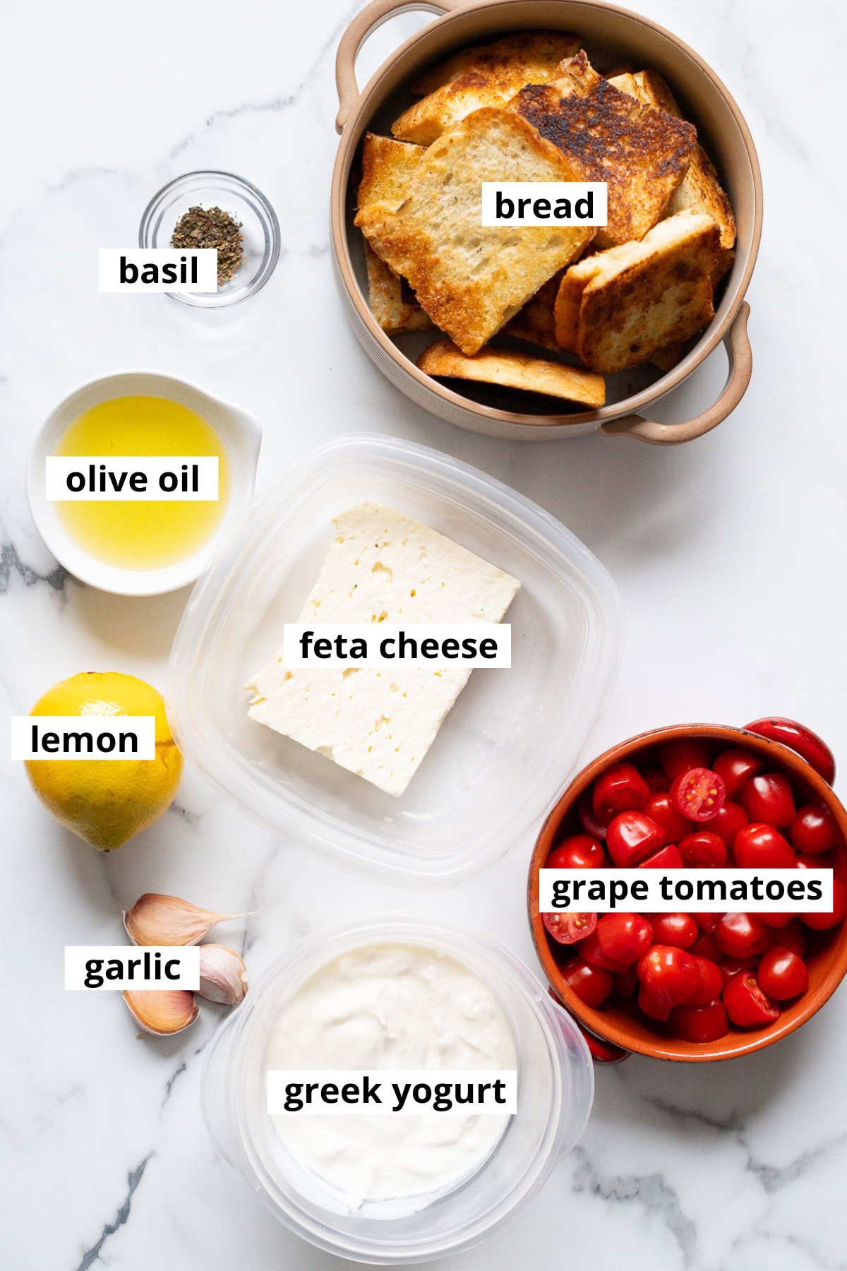 Feta cheese, Greek yogurt, olive oil, dried basil, garlic, lemon, grape tomatoes, bread.