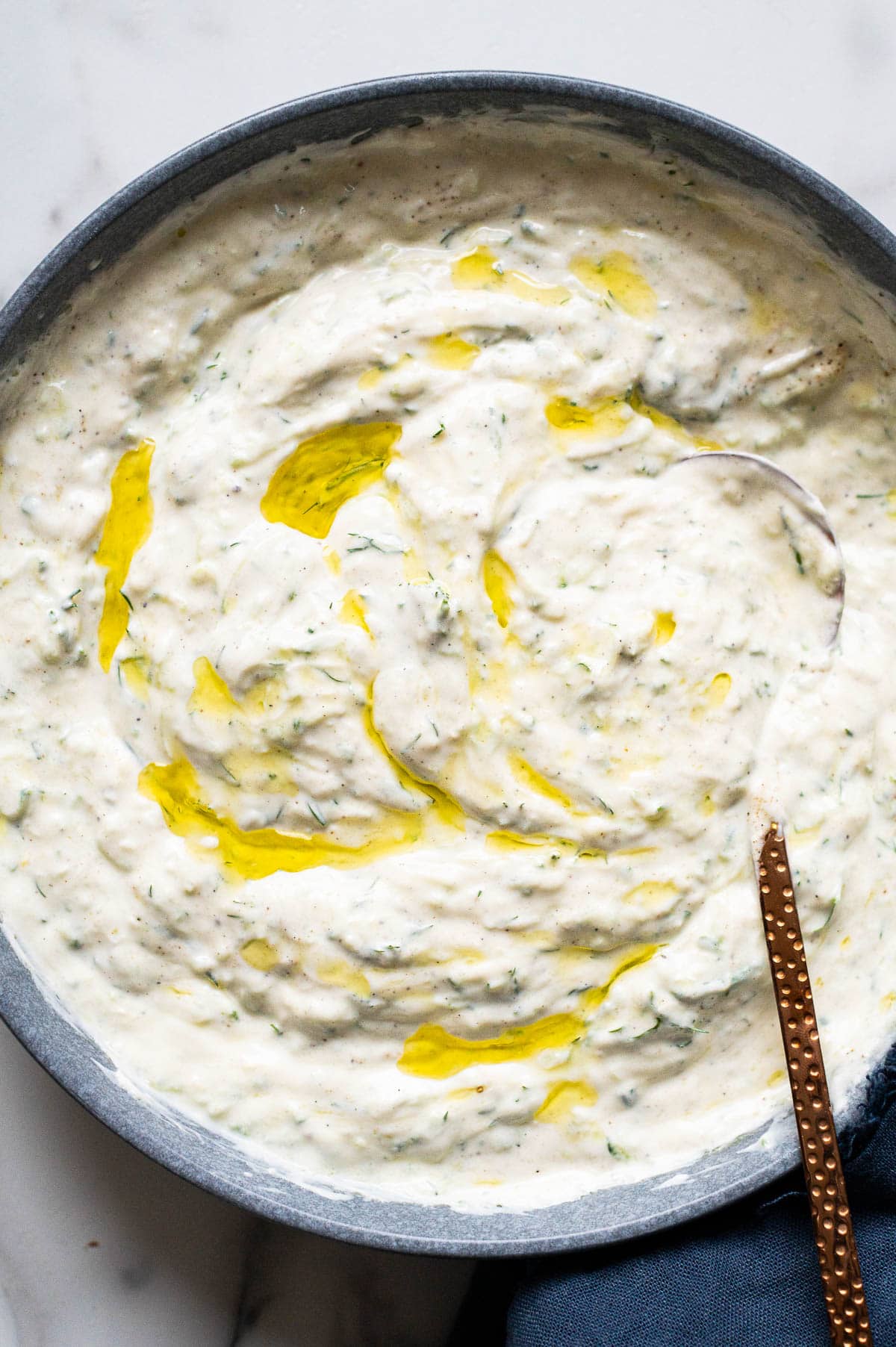 Tzatziki in a bowl with a spoon.