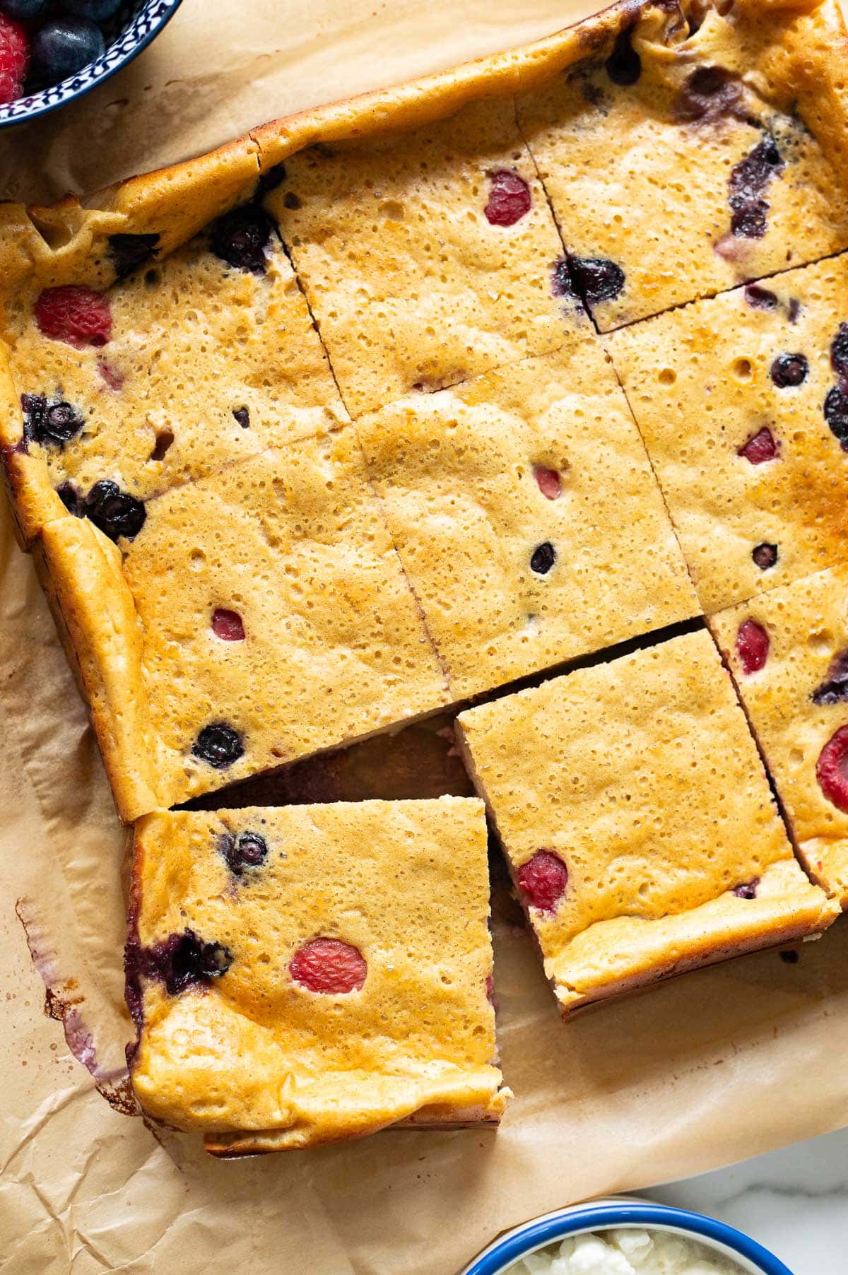 Sliced baked cottage cheese on parchment paper.