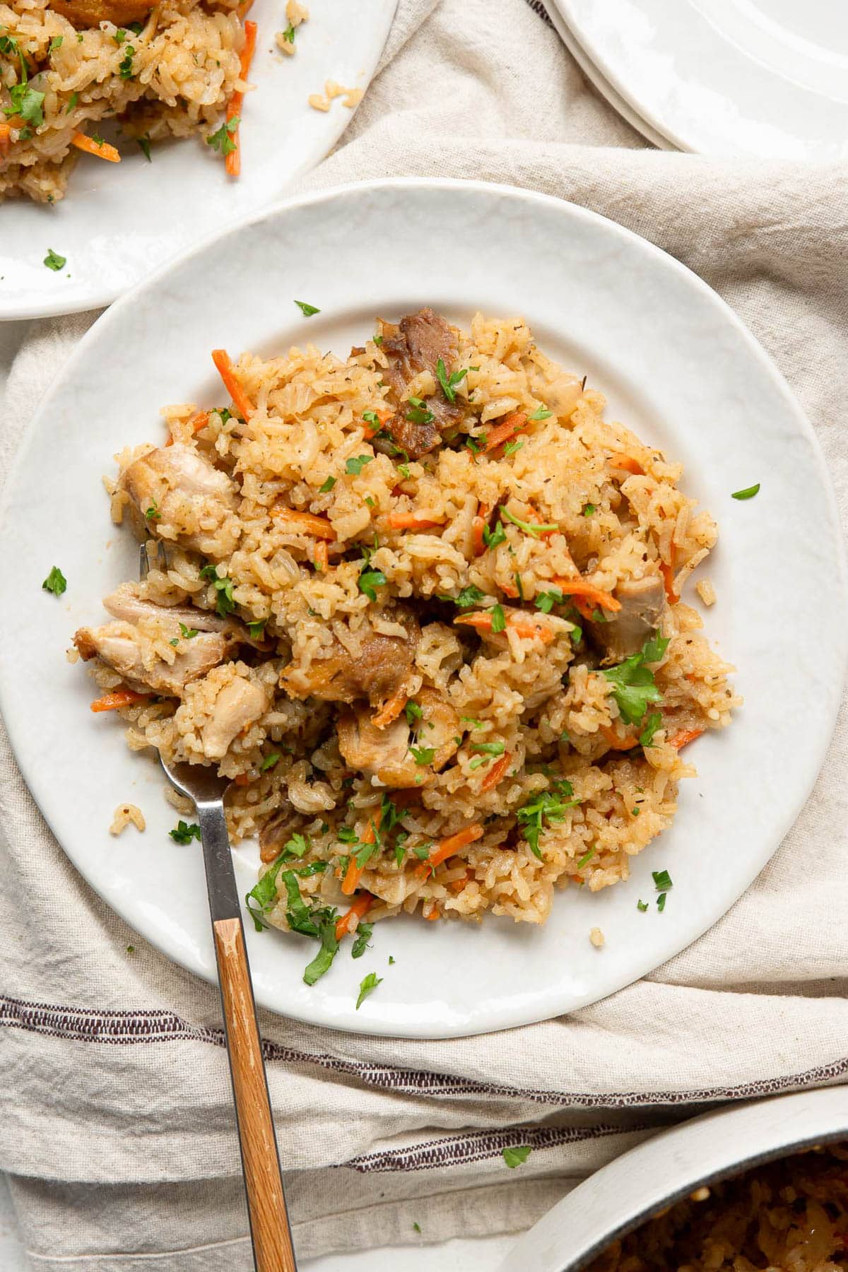 Chicken and rice served on a plate with a fork.