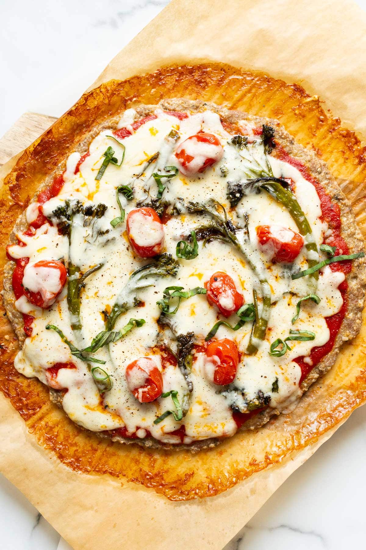 Chicken crust pizza with veggies and cheese.