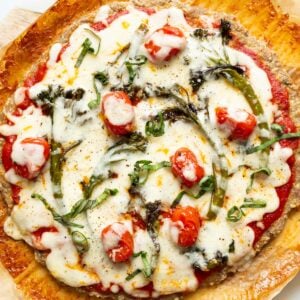 Chicken crust pizza with veggies and cheese.