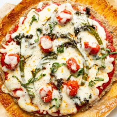 Chicken crust pizza with veggies and cheese.