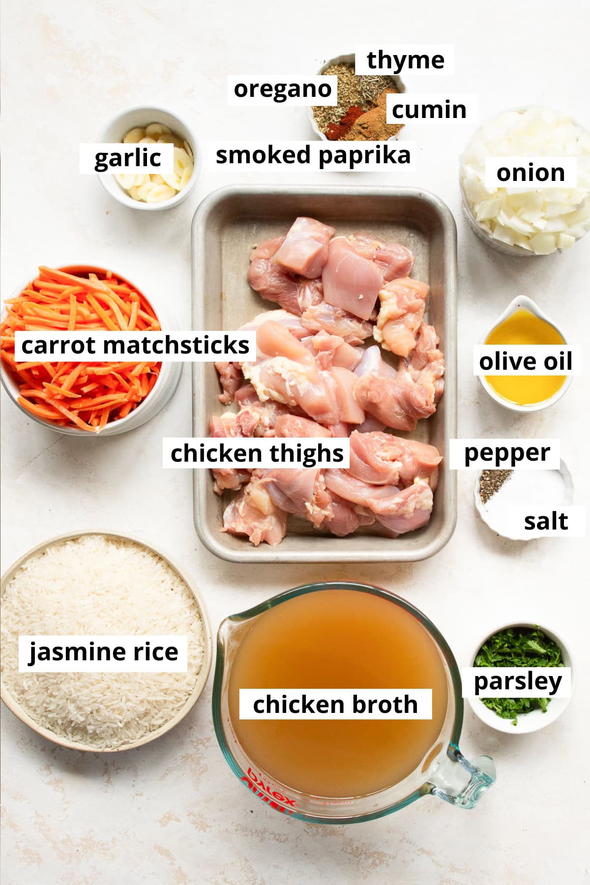 Chicken thighs, carrot matchsticks, onion, garlic, olive oil, salt, pepper, chicken broth, parsley, cumin, smoked paprika, thyme, oregano, jasmine rice.