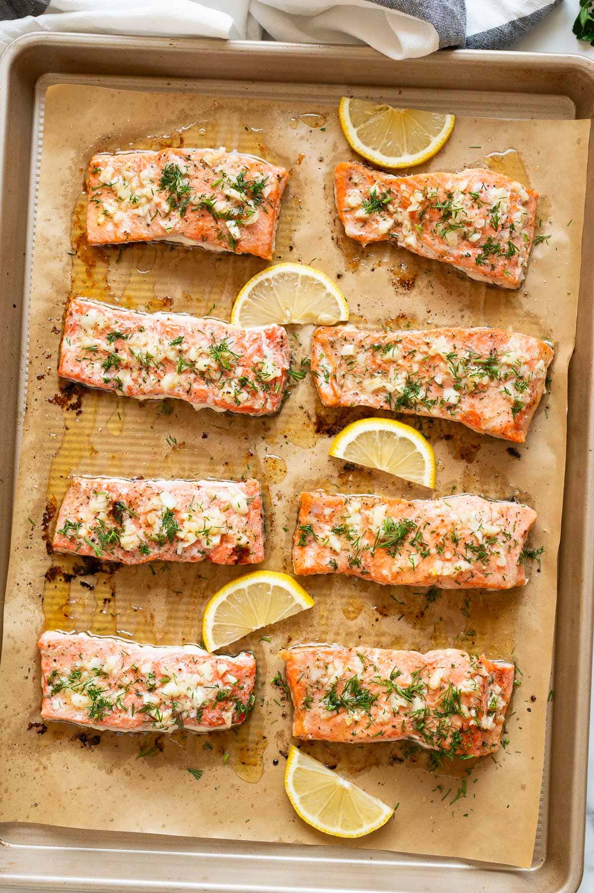 Baked salmon fillets on a baking sheet.