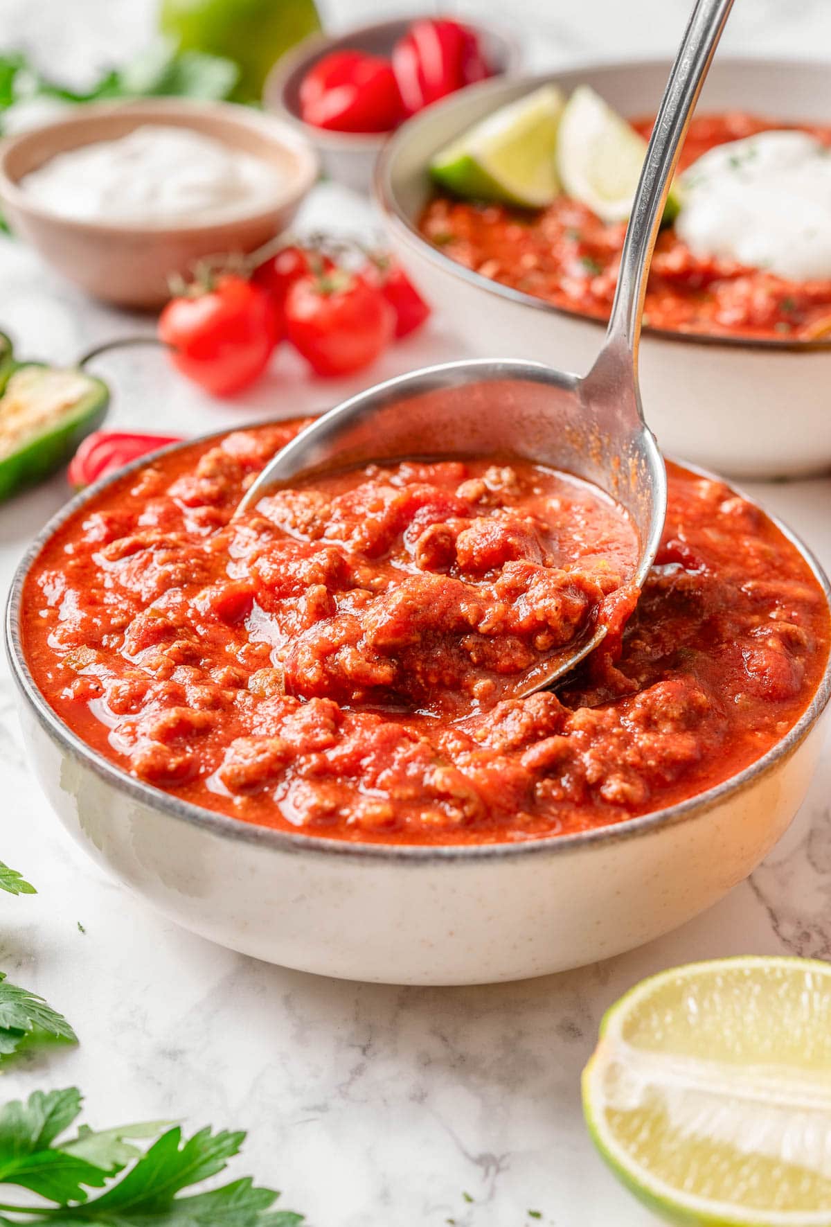 Ladling chili in a bowl.