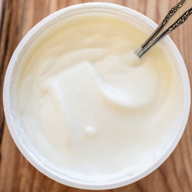 Blended cottage cheese in a container with spoon.