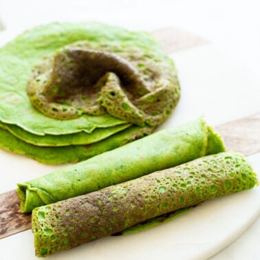 Spinach tortillas on a board.