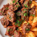 Garlic butter steak bites with potatoes on a plate.