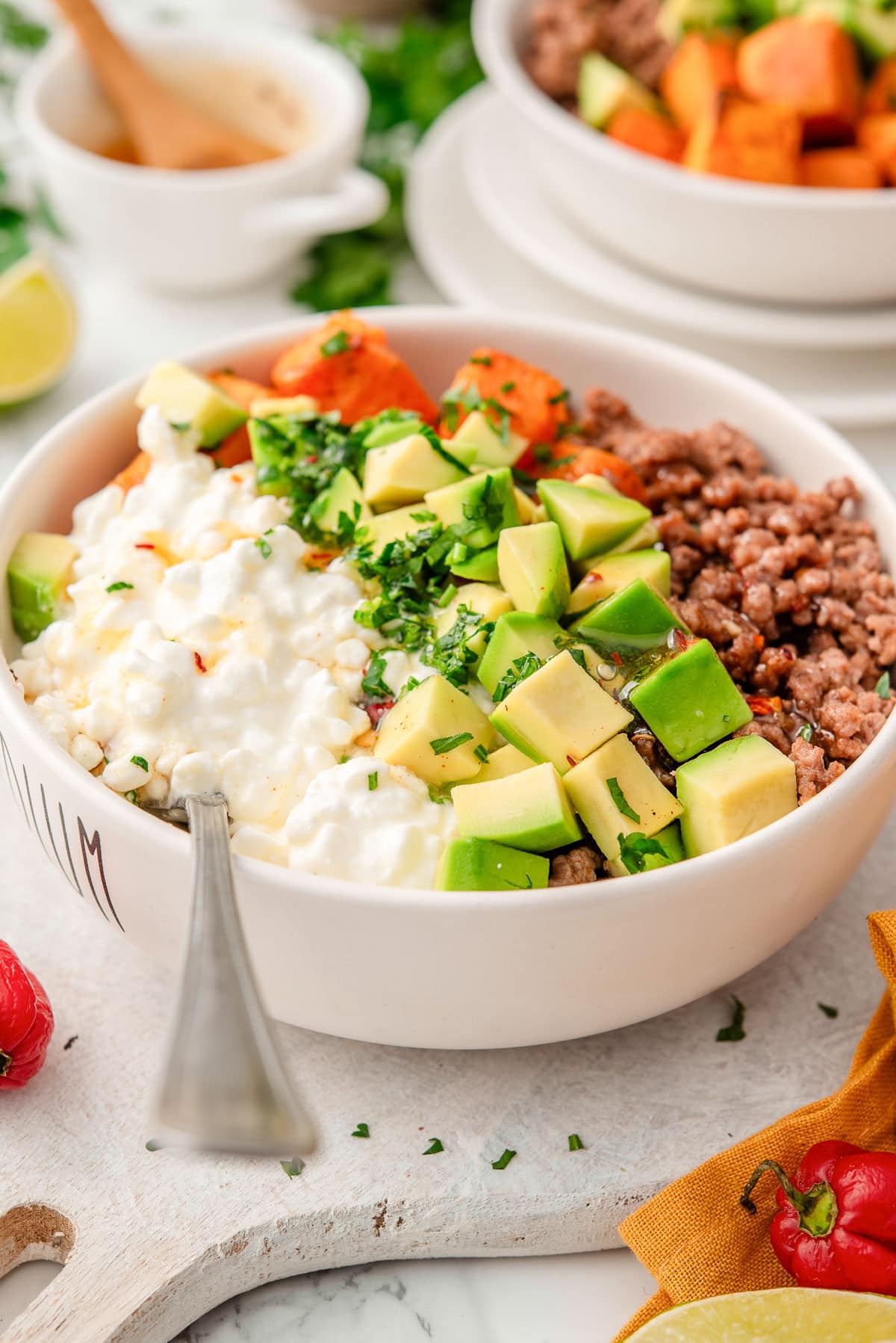 Sweet potato cottage cheese beef bowl with a spoon in it.